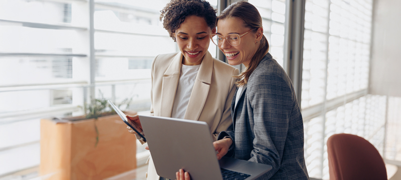 Real estate agents working together on a laptop